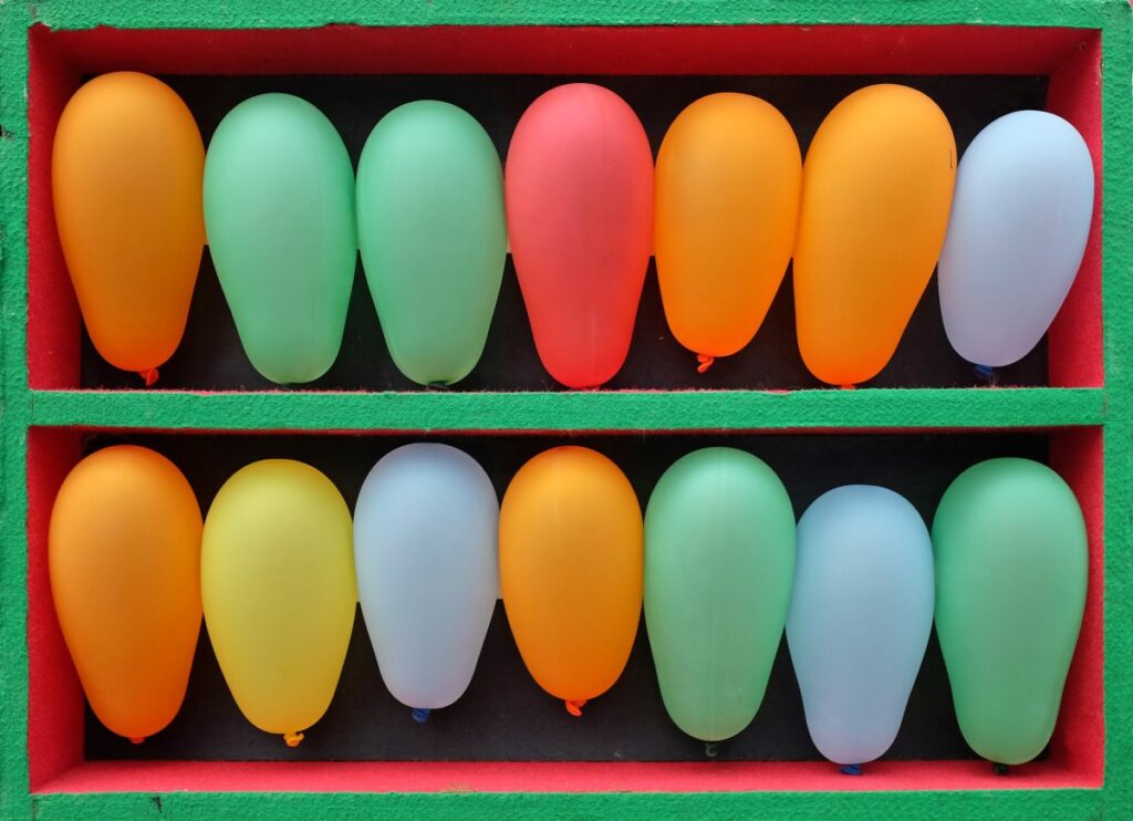 Colorful balloon dart board—fun things to do at home this summer.