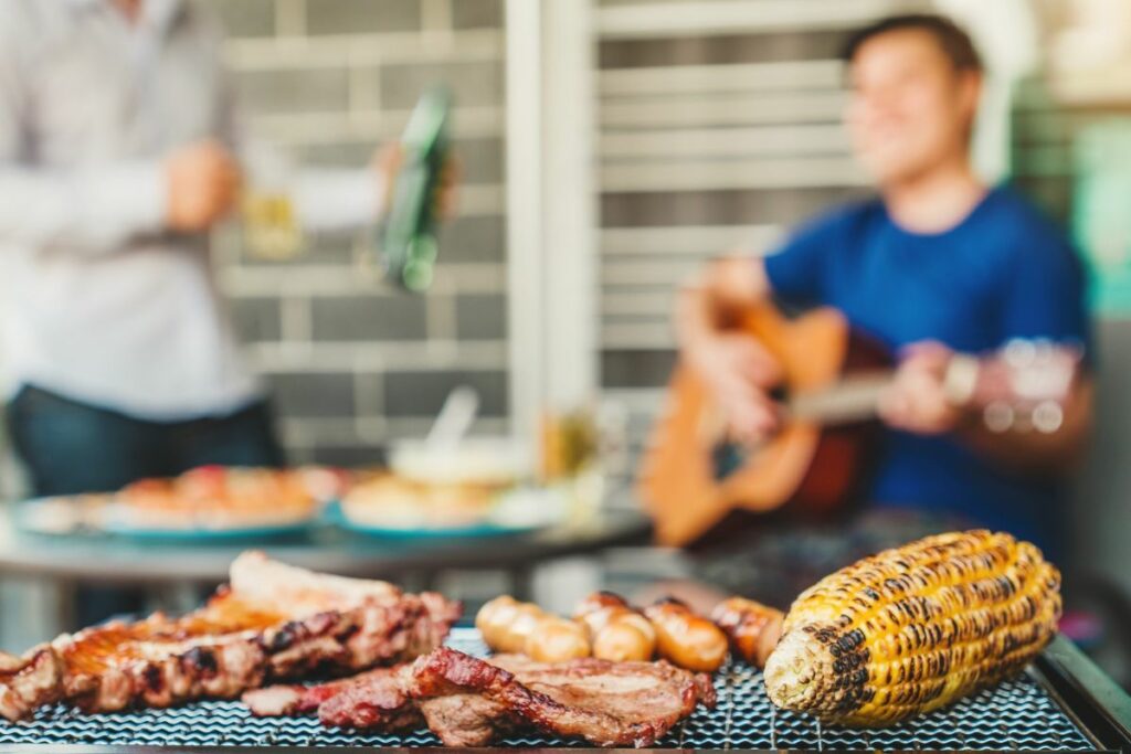 Man playing guitar at a BBQ