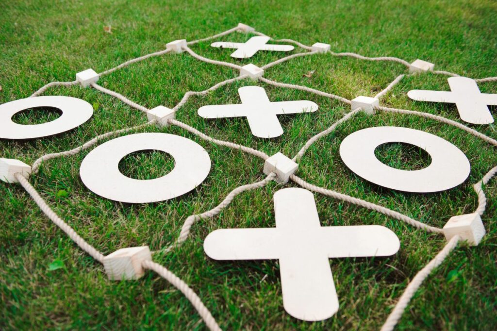 Outdoor tic-tac-toe game on grass—fun things to do at home this summer.