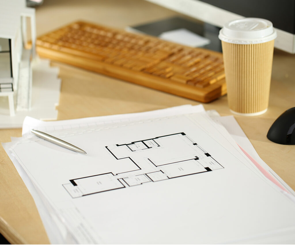 Floor plan on desk reminds you to measure dining room before choosing a table.